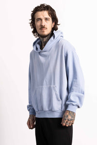 White male model with edgy style wearing a heavyweight cotton light blue hoodie