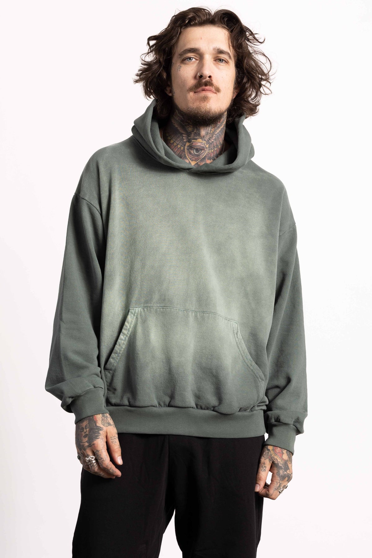 White male model with edgy style wearing a heavyweight cotton vintage green hoodie
