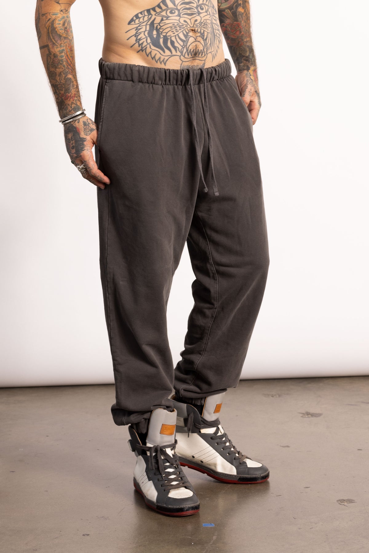 White male model with edgy style wearing a Vintage Black Pima cotton sweatpants.