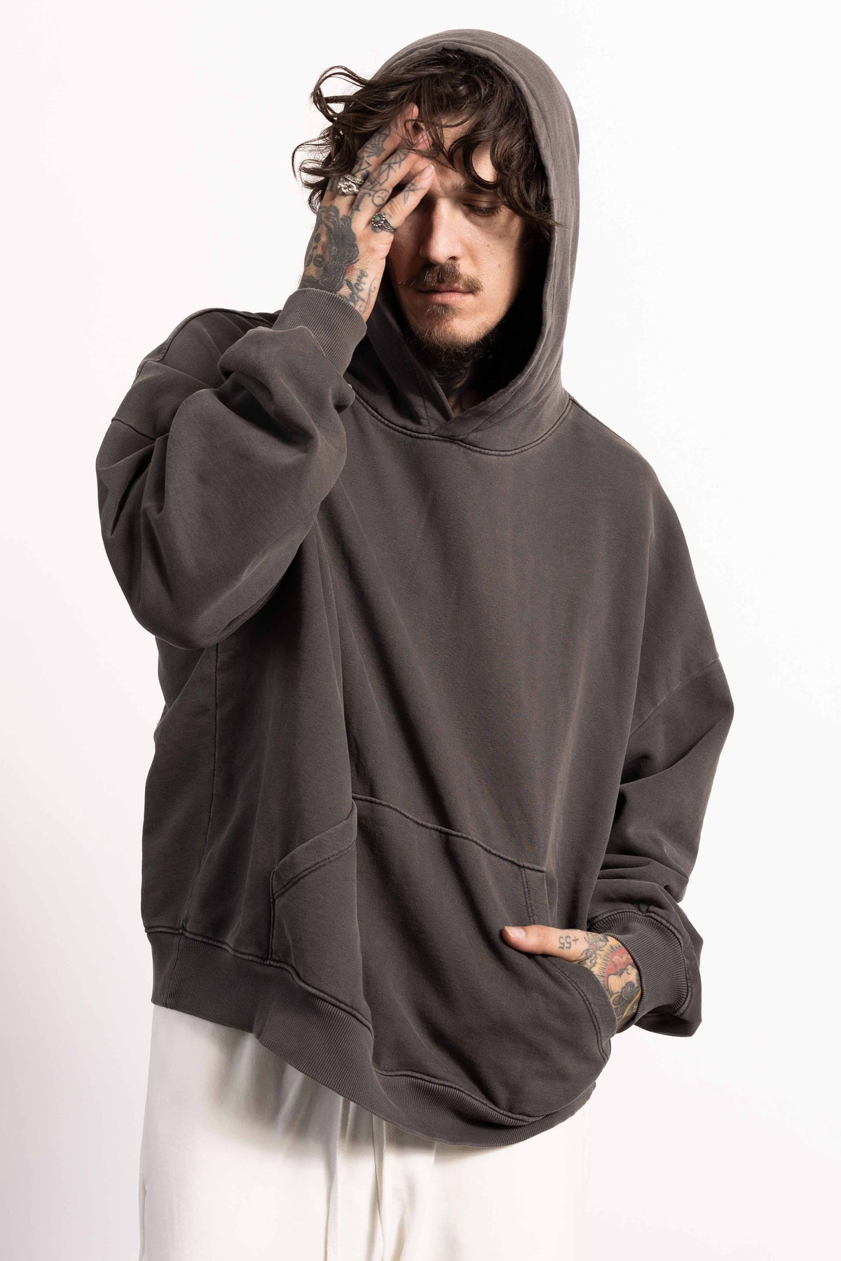 White male model with edgy style and tattoos wearing a Drop Shoulder Pima Cotton Hoodie