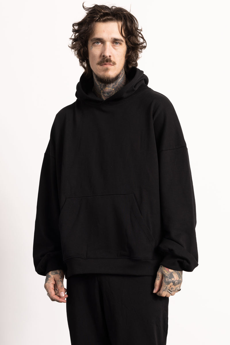 White male model with edgy style and tattoos wearing a Drop Shoulder Pima Cotton Hoodie