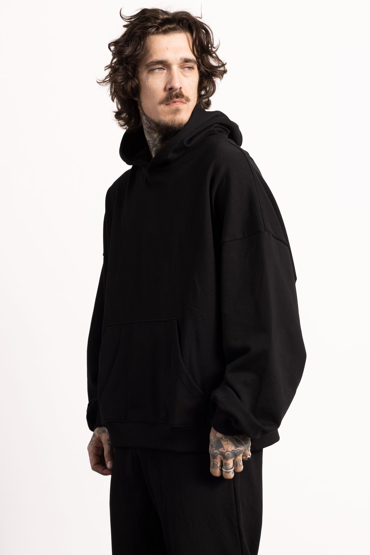 White male model with edgy style and tattoos wearing a Drop Shoulder Pima Cotton Hoodie