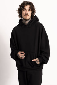 White male model with edgy style and tattoos wearing a Drop Shoulder Pima Cotton Hoodie