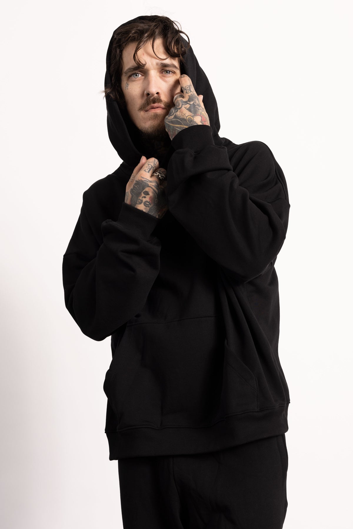 White male model with edgy style and tattoos wearing a Drop Shoulder Pima Cotton Hoodie