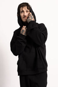 White male model with edgy style and tattoos wearing a Drop Shoulder Pima Cotton Hoodie