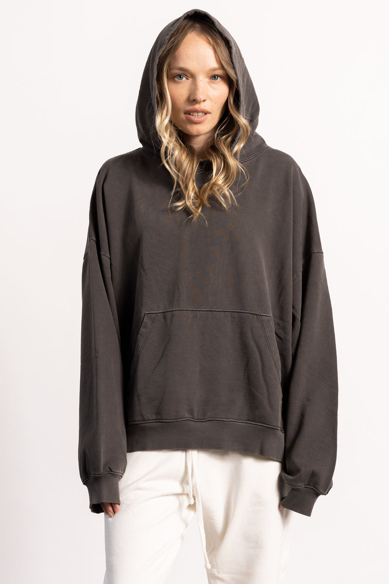 White female blonde model with edgy style wearing a drop shoulder pima cotton hoodie
