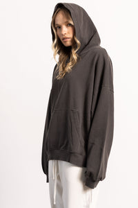 White female blonde model with edgy style wearing a drop shoulder pima cotton hoodie