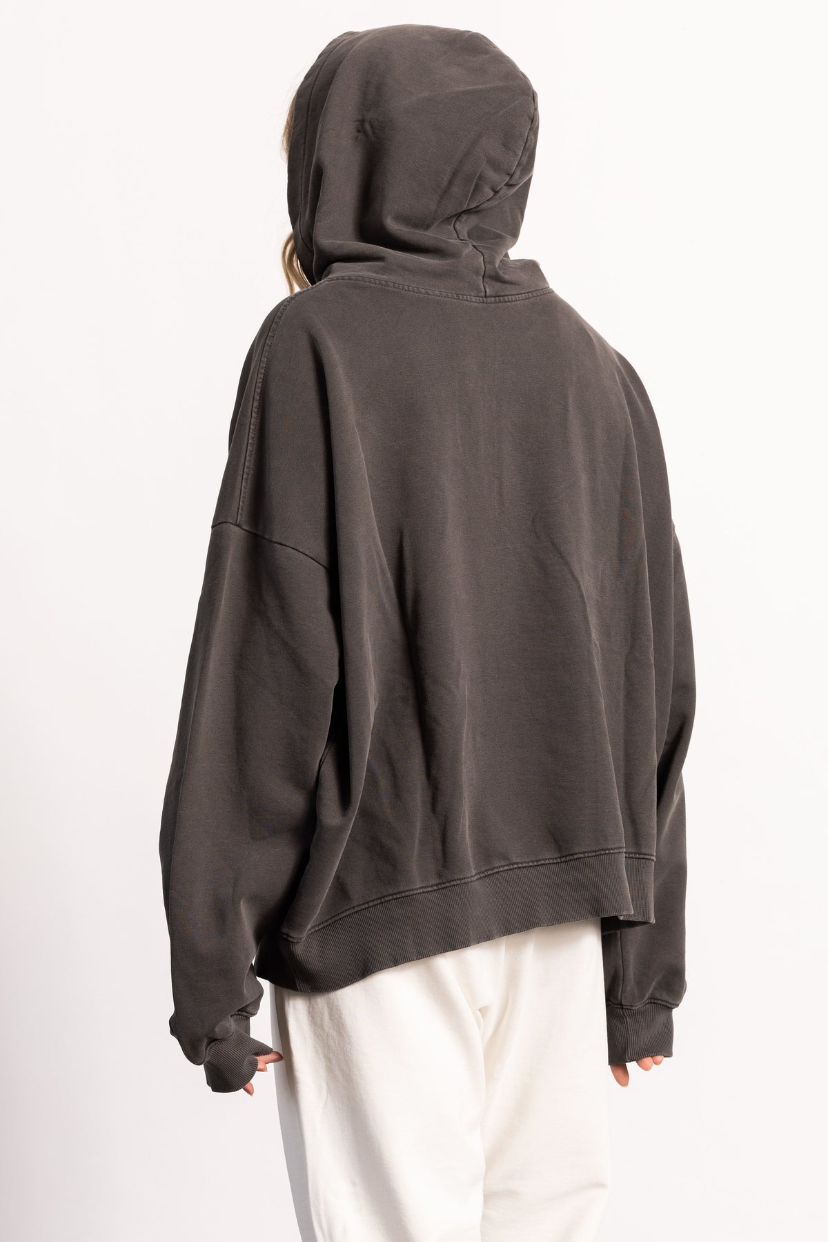 White female blonde model with edgy style wearing a drop shoulder pima cotton hoodie
