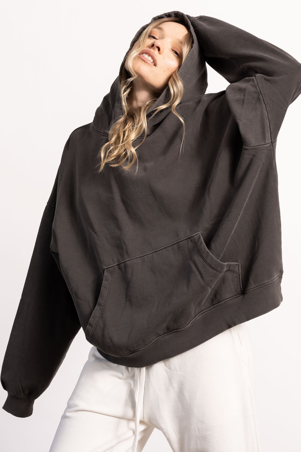 White female blonde model with edgy style wearing a drop shoulder pima cotton hoodie