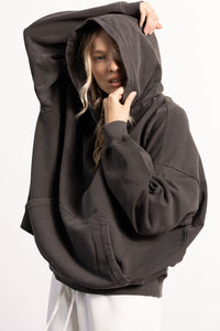 White female blonde model with edgy style wearing a drop shoulder pima cotton hoodie