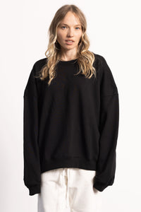 White blonde female model with edgy style wearing a heavyweight  black Pima Cotton Crewneck Sweatshirt.