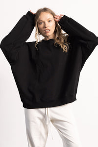 White female model with edgy style wearing a oversized sweatshirt.