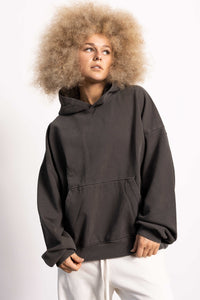 White female blonde model with edgy style wearing a drop shoulder pima cotton hoodie