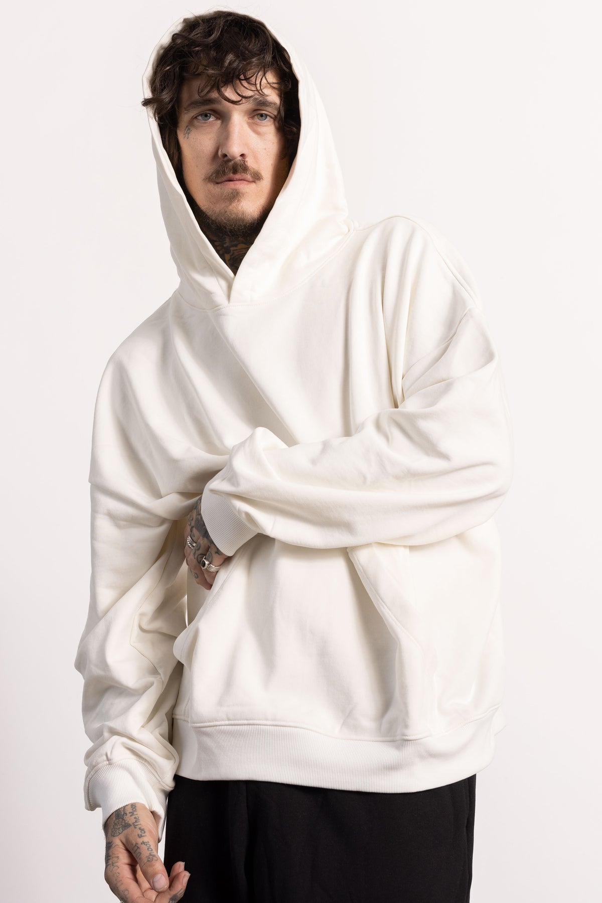 White male model with edgy style and tattoos wearing an off while Drop Shoulder Pima Cotton Hoodie