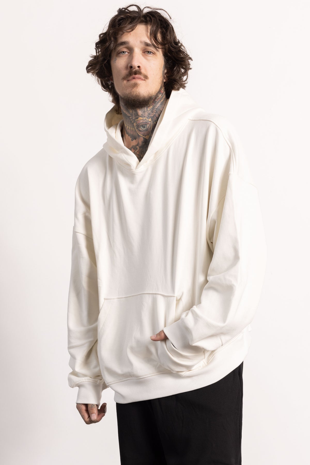 White male model with edgy style and tattoos wearing an off while Drop Shoulder Pima Cotton Hoodie