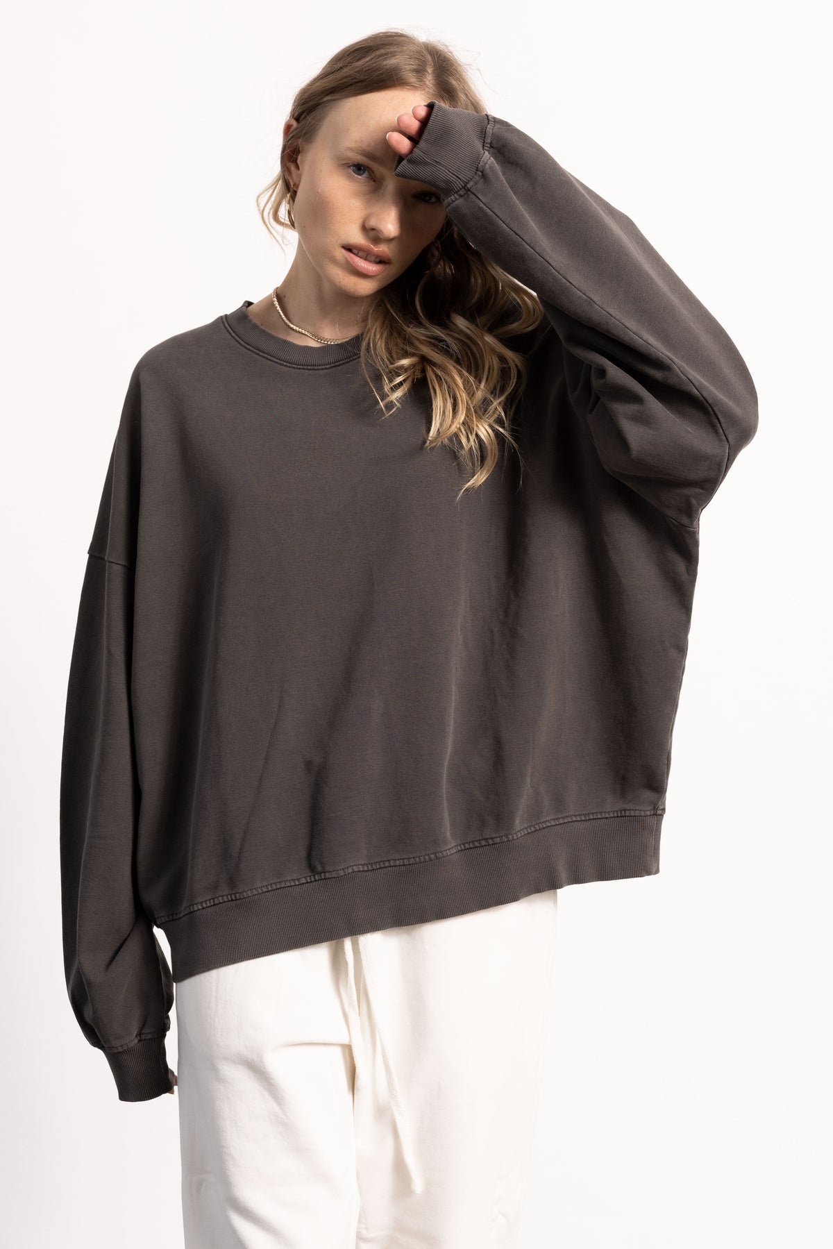 female blond model wearing an oversized sweatshirt