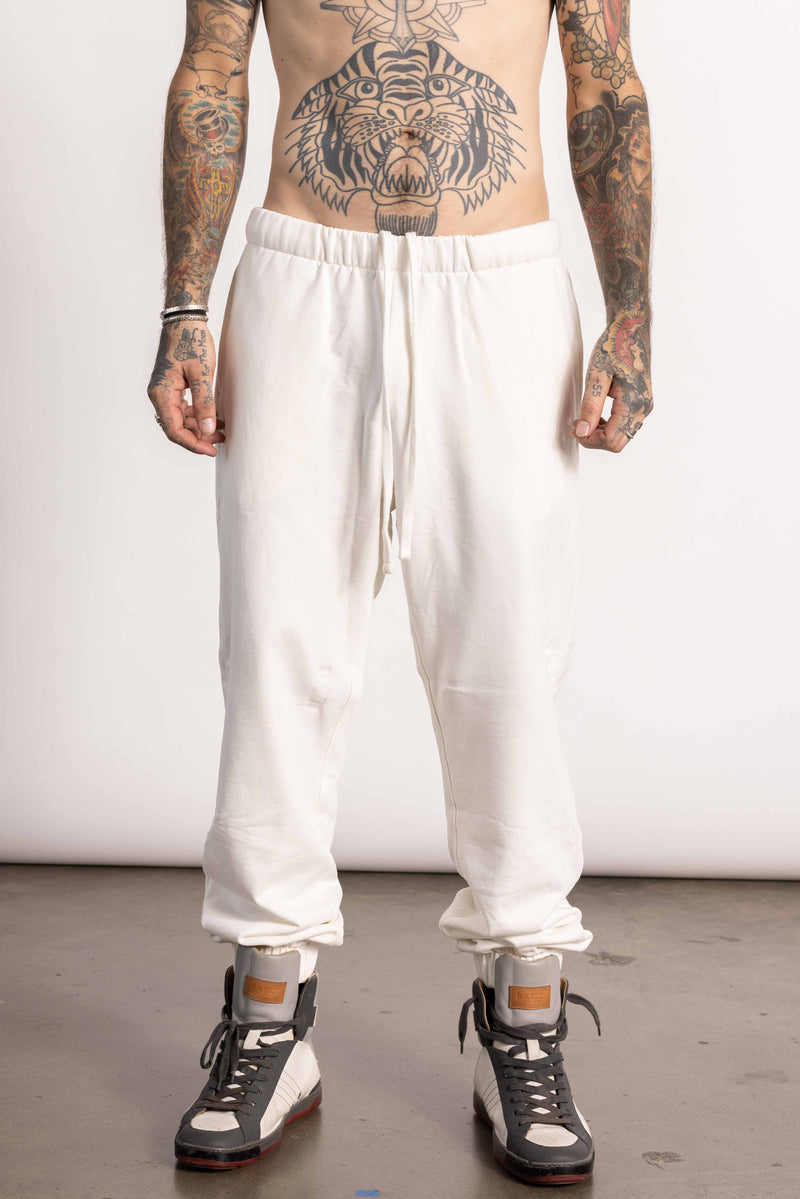 White male model with edgy style and tattoos wearing a Pima cotton sweatpants.